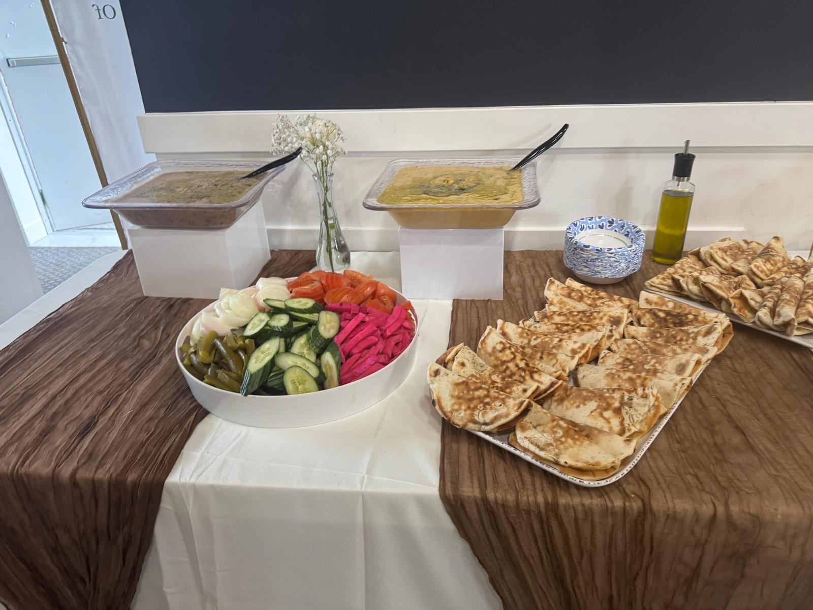 Elegant catering table with foul & manaeesh